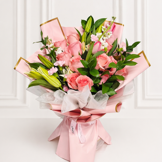 Pink lily and rose bouquet wrapped in blush paper Toronto