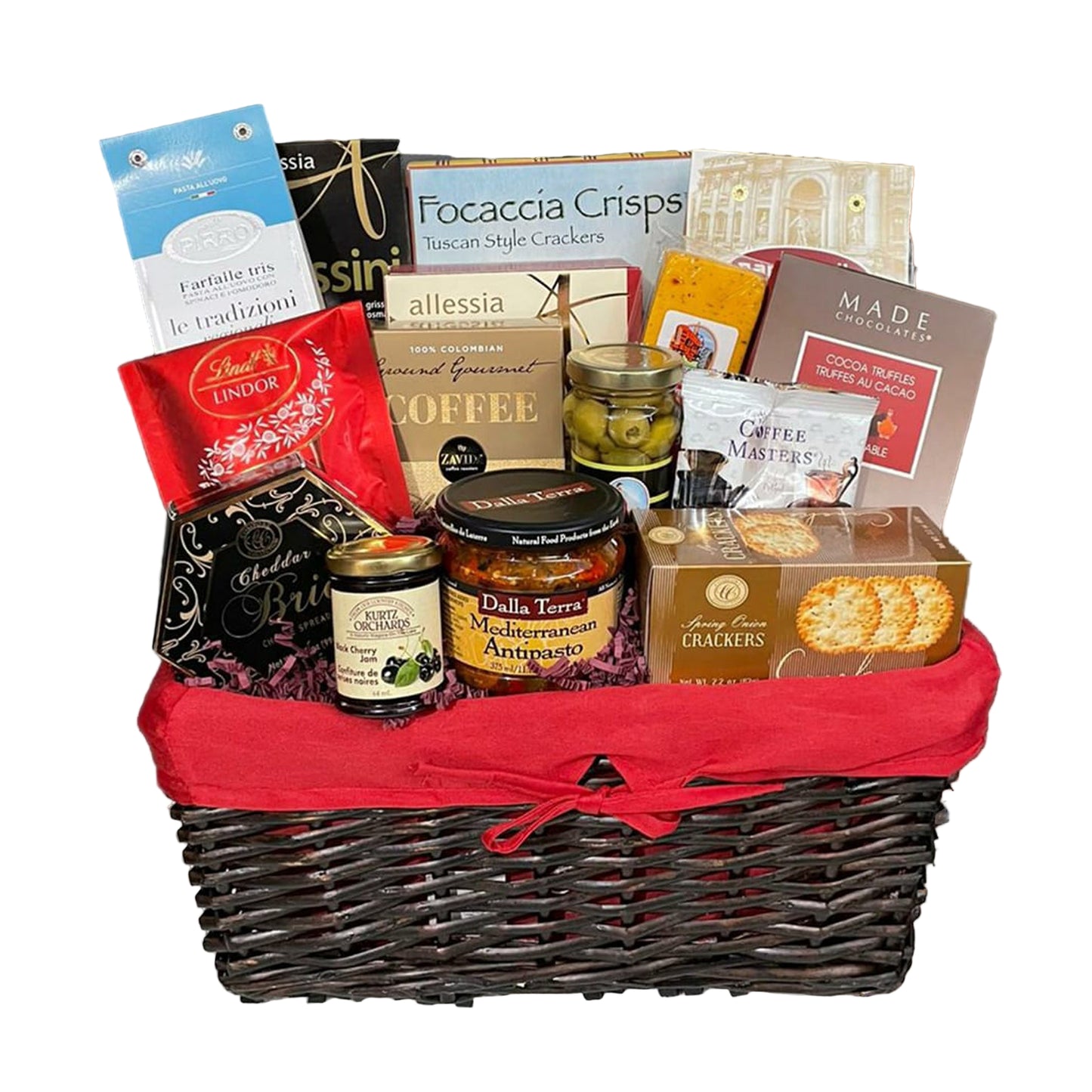 Black wicker basket filled with crackers, dips, coffee, chocolate